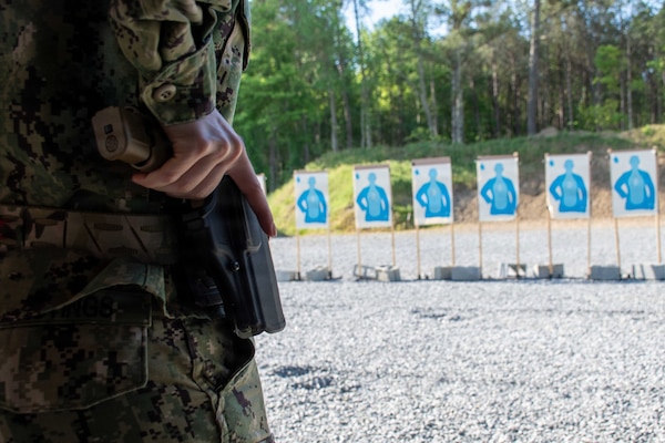 SUFFOLK, Va. (April 22, 2026) Lt. j.g. Laura Hastings, assigned to Expeditionary Medical Facility (EMF) Juliet, conducts a live-fire exercise for pistol qualification in Suffolk, Va., April 22, 2026. The week-long training exercise brought Naval Medical Forces Atlantic (NMFL) and Naval Medical Forces Pacific (NMFP) Expeditionary Medicine (ExMed) Sailors together for standardized combat skills training. (U.S. Navy photo by Mass Communication Specialist 2nd Class Thomas Boatright)