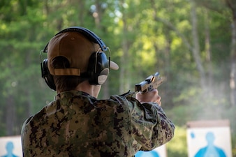 SUFFOLK, Va. (April 22, 2026) Lt. j.g. Laura Hastings, assigned to Expeditionary Medical Facility (EMF) Juliet, conducts a live-fire exervise for pistol certification in Suffolk, Va., April 22, 2026. The week-long training exercise brought Naval Medical Forces Atlantic (NMFL) and Naval Medical Forces Pacific (NMFP) Expeditionary Medicine (ExMed) Sailors together for standardized combat skills training. (U.S. Navy photo by Mass Communication Specialist 2nd Class Thomas Boatright)