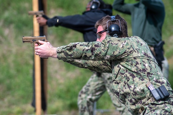 SUFFOLK, Va. (April 22, 2026) Lt. Cmdr. Brendan O'Shea, assigned to Expeditionary Medical Facility (EMF) Juliet, conducts a live-fire exercise for pistol qualification in Suffolk, Va., April 22, 2026. The week-long training exercise brought Naval Medical Forces Atlantic (NMFL) and Naval Medical Forces Pacific (NMFP) Expeditionary Medicine (ExMed) Sailors together for standardized combat skills training. (U.S. Navy photo by Mass Communication Specialist 2nd Class Thomas Boatright)