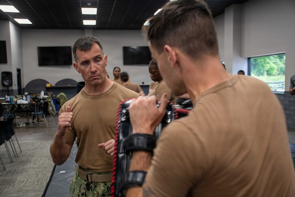 SUFFOLK, Va. (April 22, 2026) Lt. Cmdr. Derrick O'Neal, assigned to Expeditionary Medical Facility (EMF) Alpha, practices personal defense combat skills in Suffolk, Va., April 22, 2026. The week-long training exercise brought Naval Medical Forces Atlantic (NMFL) and Naval Medical Forces Pacific (NMFP) Expeditionary Medicine (ExMed) Sailors together for standardized combat skills training. (U.S. Navy photo by Mass Communication Specialist 2nd Class Thomas Boatright)