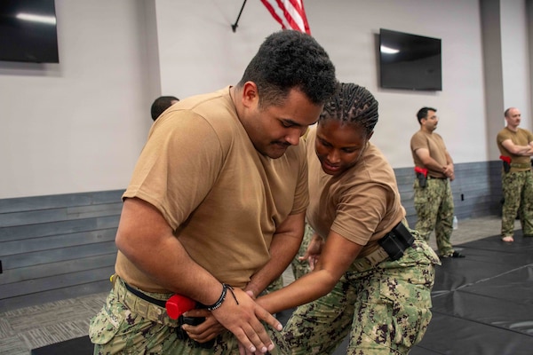 SUFFOLK, Va. (April 22, 2026) Information Systems Technician Seaman Jermaine CastilloMercado, assigned to Expeditonary Medical Unit Seven (EMU-7) and Lt. j.g. Sterna Smith, assigned to Expeditionary Medical Facility (EMF) Alpha, practice maintaining positive control on their firearm in Suffolk, Va., April 22, 2026. The week-long training exercise brought Naval Medical Forces Atlantic (NMFL) and Naval Medical Forces Pacific (NMFP) Expeditionary Medicine (ExMed) Sailors together for standardized combat skills training. (U.S. Navy photo by Mass Communication Specialist 2nd Class Thomas Boatright)