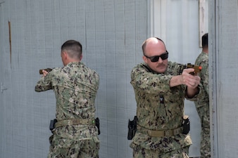SUFFOLK, Va. (April 22, 2026) Hospital Corpsman 2nd Class Nicholas Moubarak, assigned to Expeditionary Resuscitative Surgical System (ERSS) Three, and Lt. Cmdr. Derrick O'Neal, assigned to Expeditionary Medical Facility (EMF) Alpha, conduct close quarter combat (CQC) training in Suffolk, Va., April 22, 2026. The week-long training exercise brought Naval Medical Forces Atlantic (NMFL) and Naval Medical Forces Pacific (NMFP) Expeditionary Medicine (ExMed) Sailors together for standardized combat skills training. (U.S. Navy photo by Mass Communication Specialist 2nd Class Thomas Boatright)
