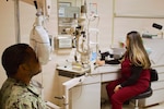 Catherine Ortiz (right), a Doctor of Optometry student from Western University of Health Sciences, conducts an eye examination with Hospital Corpsman 2nd Class Emilio Matthew at Naval Hospital Twentynine Palms in April 2026. Ortiz completed a clinical rotation at the hospital as part of a partnership that provides optometry students with hands-on experience in a military healthcare environment. (U.S. Navy photo by Hospital Apprentice Evelyn Zermeno)