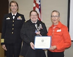 Lt. Erica Fallon (middle) Naval Hospital Bremerton Physical and Occupational Therapy department head was recognized as a MOAA Junior Officer of the Year by The Military Officers Association of America, Kitsap Chapter, May 15, 2026. Fallon was presented the award by retired U.S. Army Col. Char Godec (right), after being introduced to attendees at the Armed Forces Week luncheon by Capt. Karla Lepore (left) Naval Hospital Bremerton director and Navy Medicine Readiness Training Command Bremerton commanding officer (Official Navy photo by Douglas H Stutz, NHB/NMRTC Bremerton public affairs)