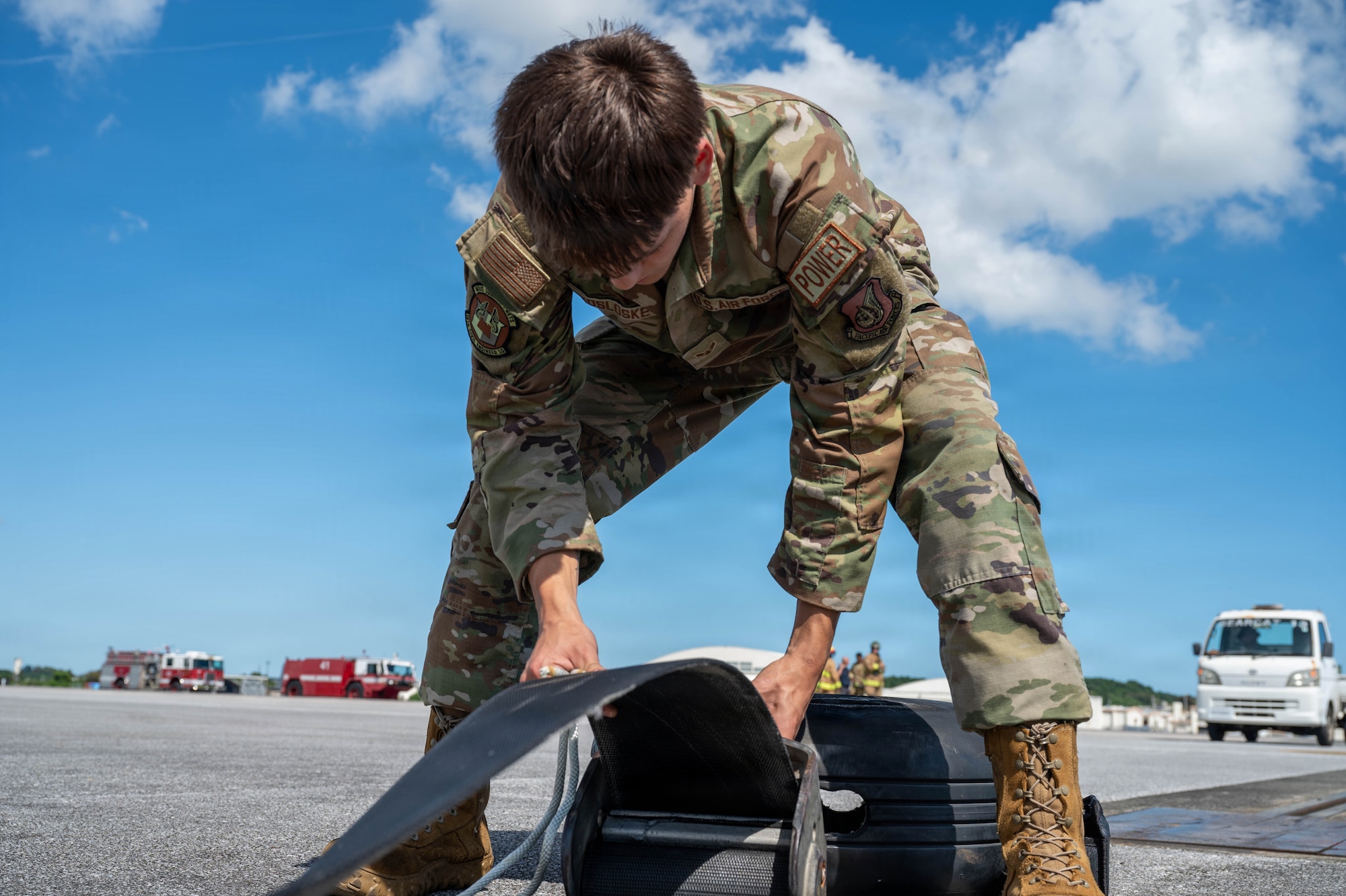 Service member works on machinery.