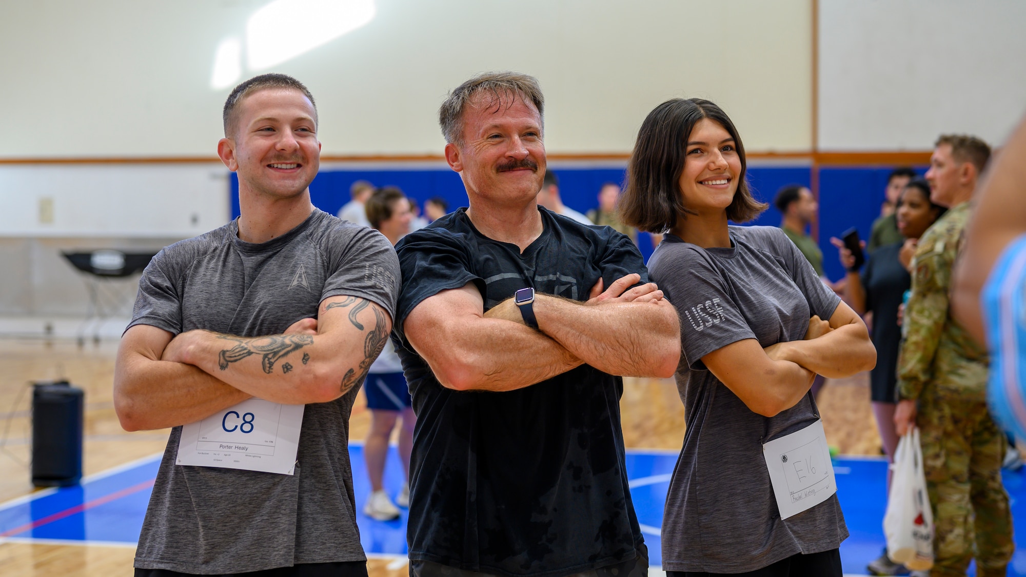 U.S. Air Force Chief Master Sgt. William Cupp, center, 18th Wing command chief, poses with U.S. Space Force Spc. 3 Porter Healy, left, and Spc. 3 Rachel Wieting, 53rd Space Operations Squadron satellite controllers, during the Warrior Gauntlet at Kadena Air Base, Japan, May 8, 2026. The event fostered camaraderie and reinforced a shared commitment to maintaining a free and open Indo-Pacific. (U.S. Air Force photo by Airman 1st Class Francisco Huerta)