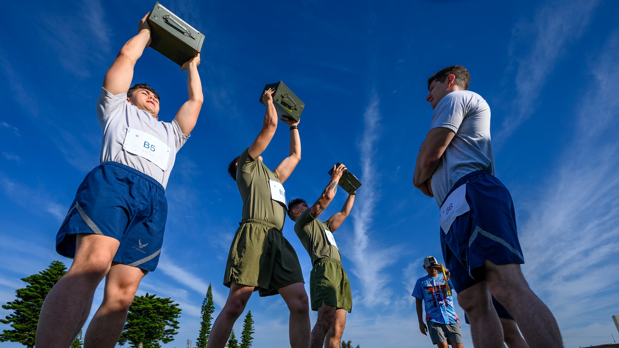 U.S. service members lift ammunition cans during the Warrior Gauntlet at Kadena Air Base, Japan, May 8, 2026. The event tested strength, endurance and resilience through challenges inspired by each branch’s physical fitness standards. (U.S. Air Force photo by Airman 1st Class Francisco Huerta)