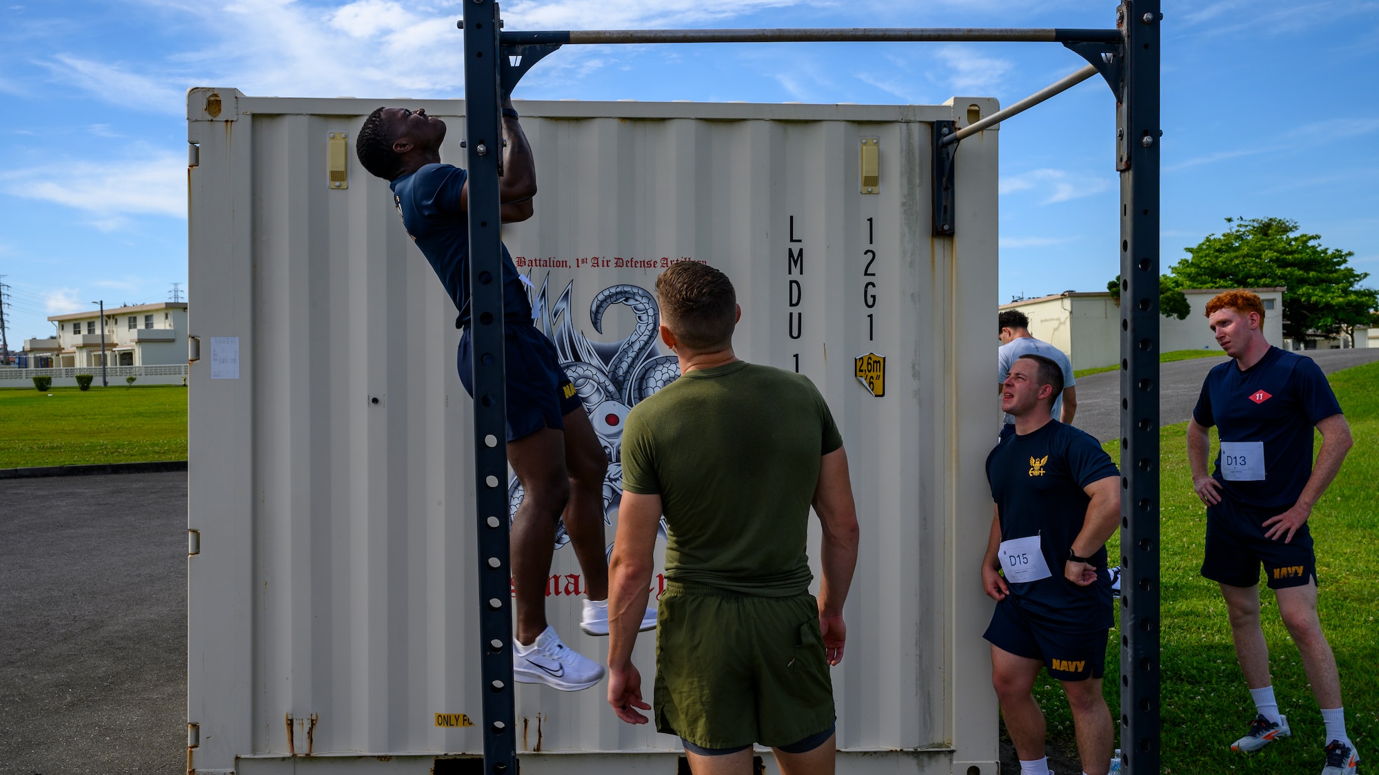 A U.S. Navy Sailor performs pull-ups during the Warrior Gauntlet at Kadena Air Base, Japan, May 8, 2026. The gauntlet challenged competitors through a series of strength and endurance-based events designed to build a fit-to-fight force. (U.S. Air Force photo by Airman 1st Class Francisco Huerta)
