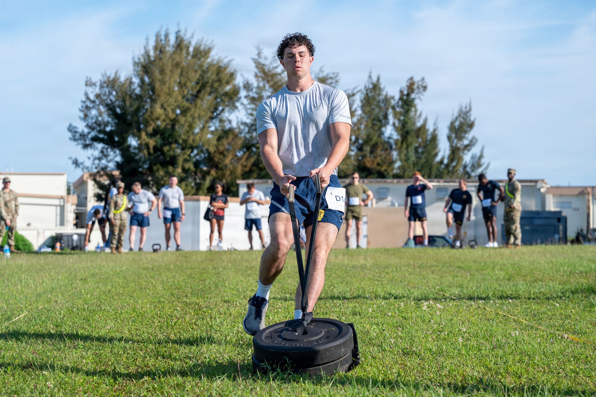 A U.S. Air Force Airman assigned to the 18th Wing pulls weights during the Warrior Gauntlet at Kadena Air Base, Japan, May 8, 2026. The course combined 10 exercises compiling physical fitness assessments of each military branch, designed to test endurance, strength and overall readiness. (U.S. Air Force photo by Senior Airman Greydon Furstenau)
