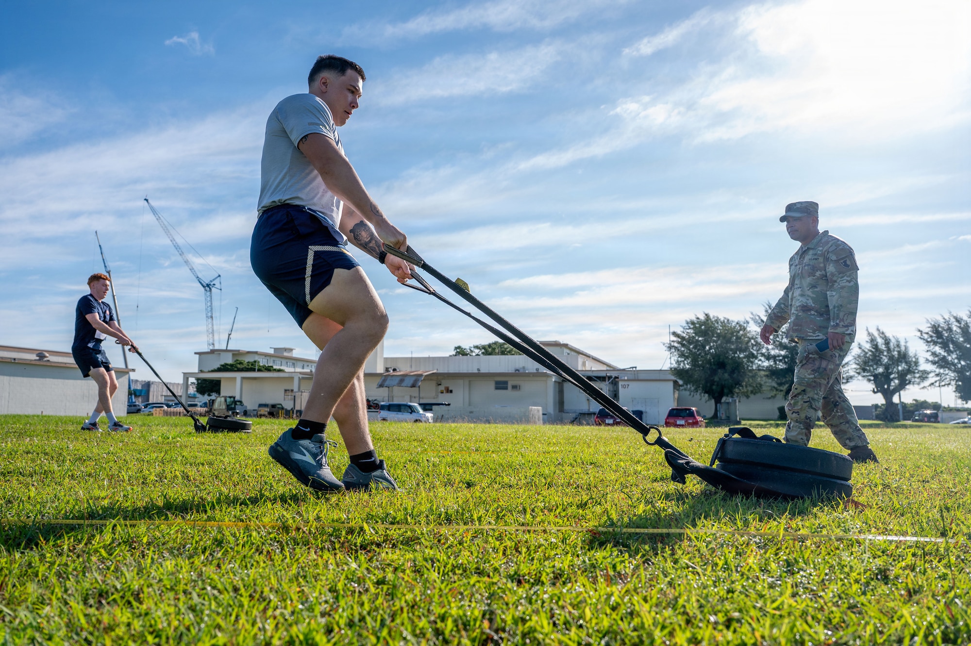 U.S. service members pull weights during the Warrior Gauntlet at Kadena Air Base, Japan, May 8, 2026. The event challenged participants to perform across multiple fitness standards in a joint environment. (U.S. Air Force photo by Senior Airman Greydon Furstenau)