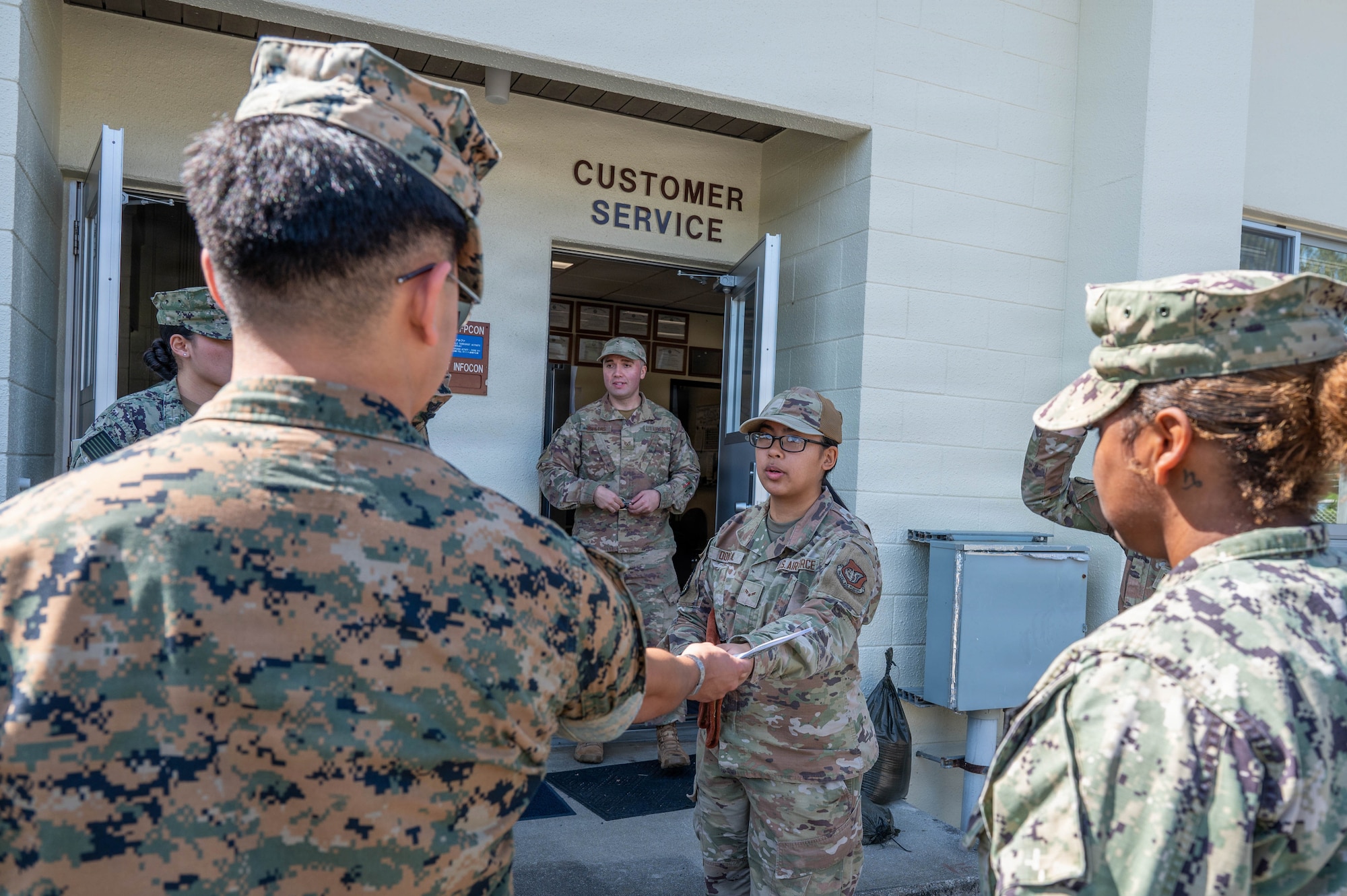 Service member hands out pamphlets.