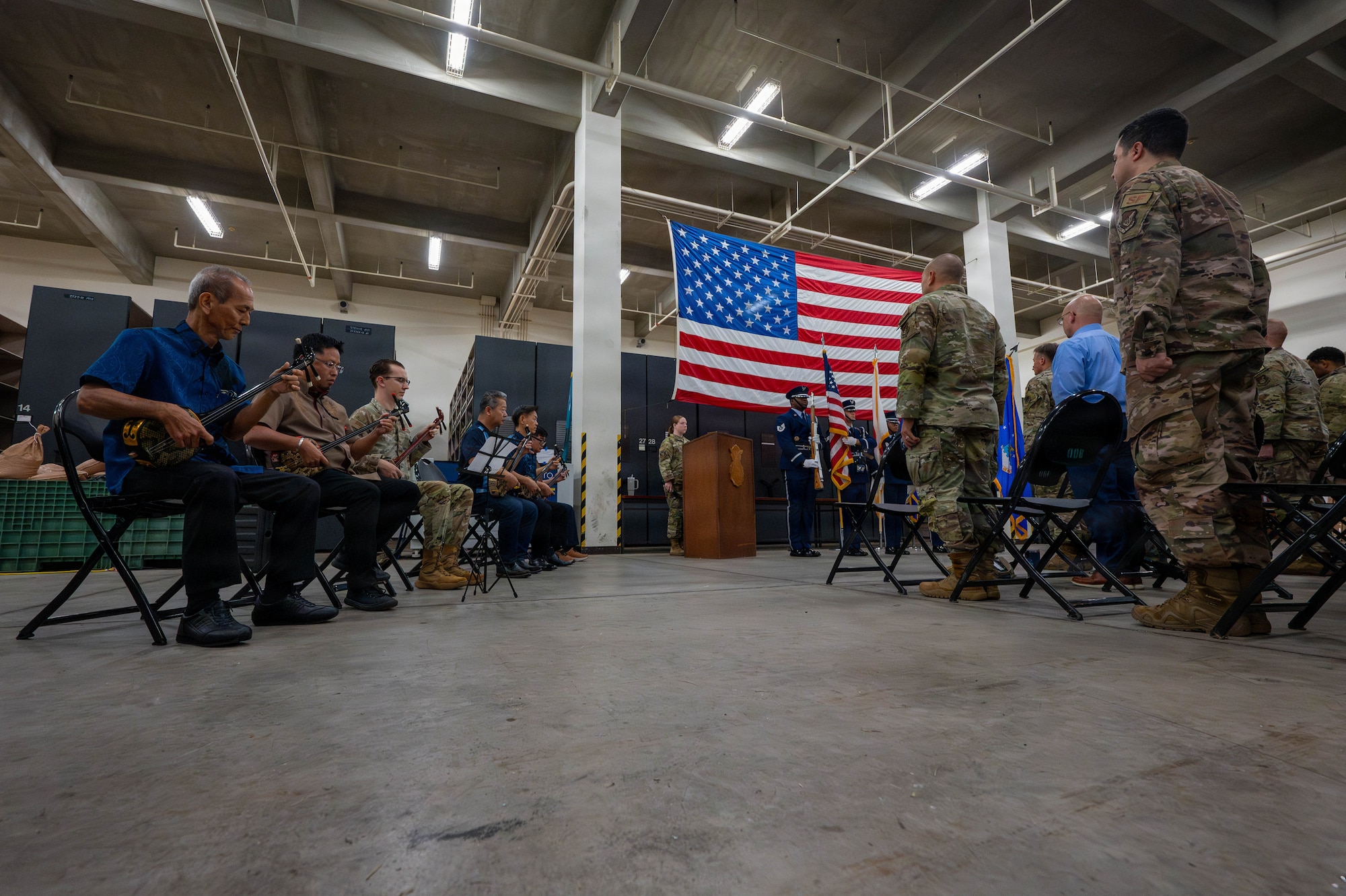 U.S. Air Force Airmen assigned to the 18th Security Forces Squadron stand during the playing of the Pledge of Allegiance.