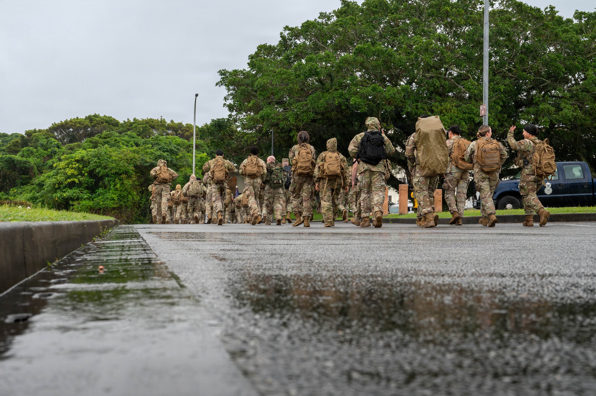 Servicemembers walk down a path.