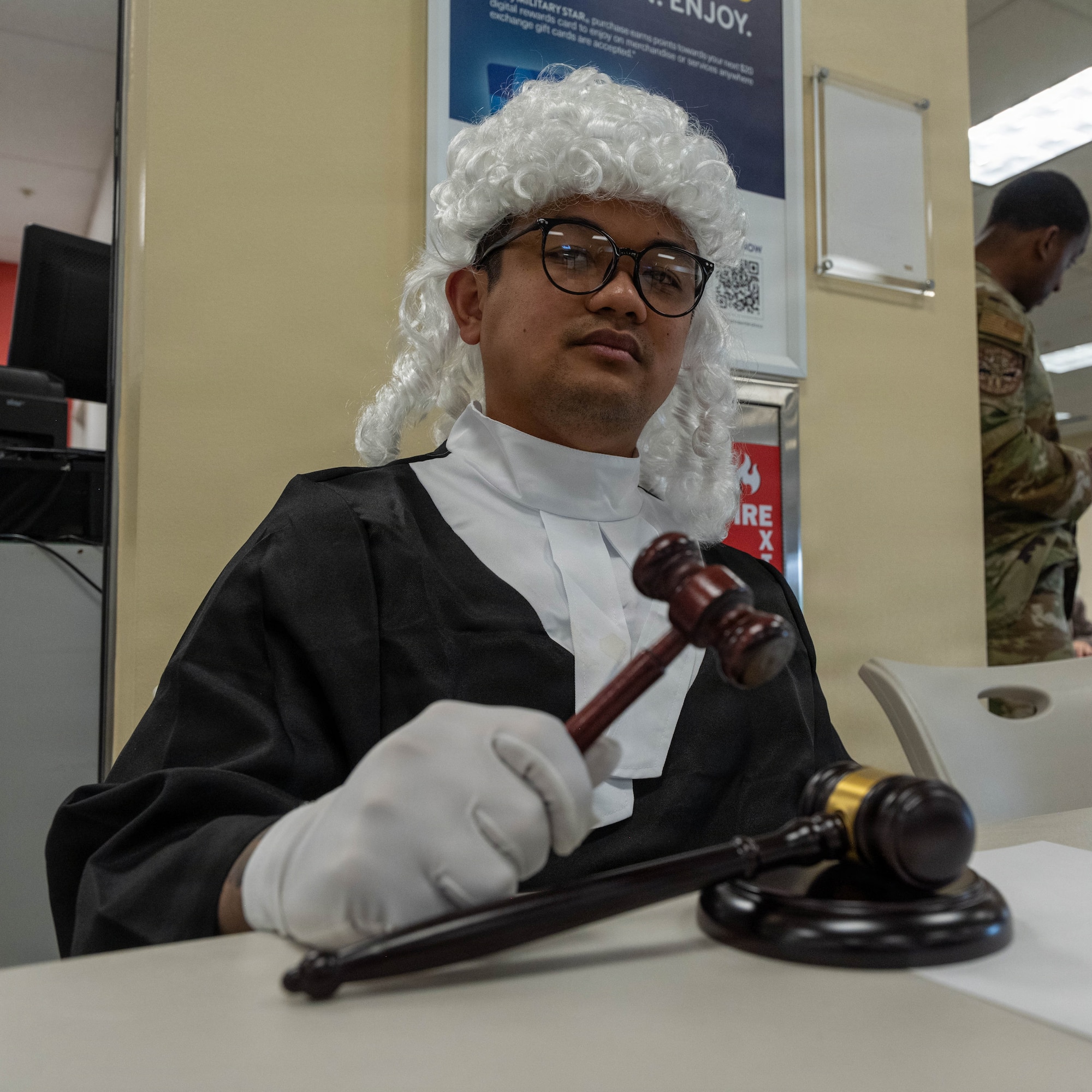 Airman poses with gavel.