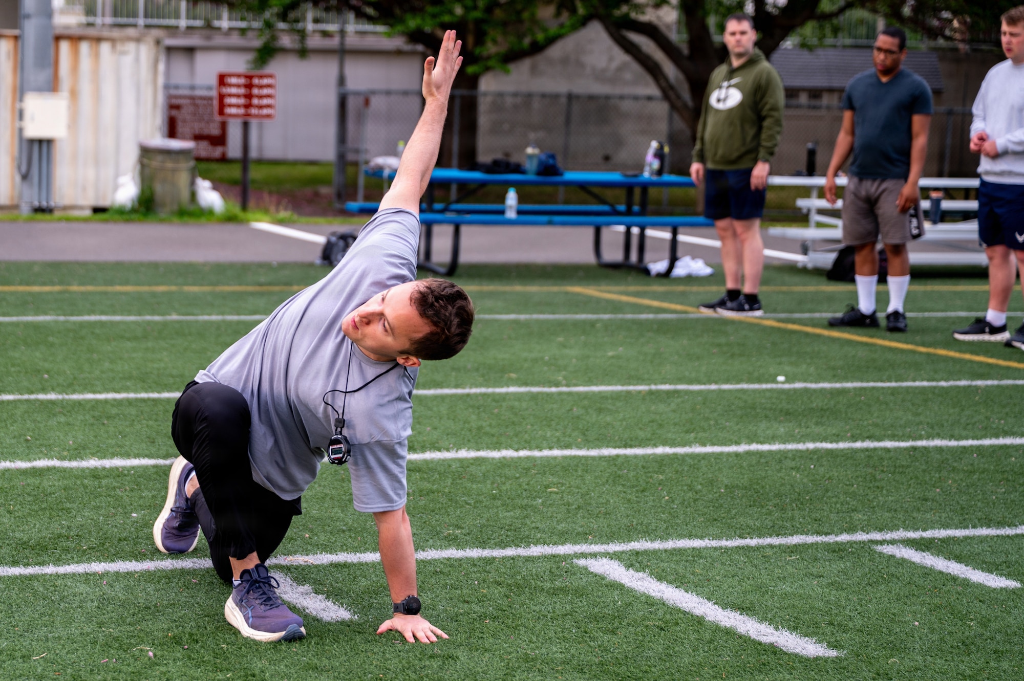 U.S. Air Force 1st Lt. Jackson Disilvestre, 13th Fighter Squadron chief of intelligence, demonstrates a stretching exercise during a running clinic.
