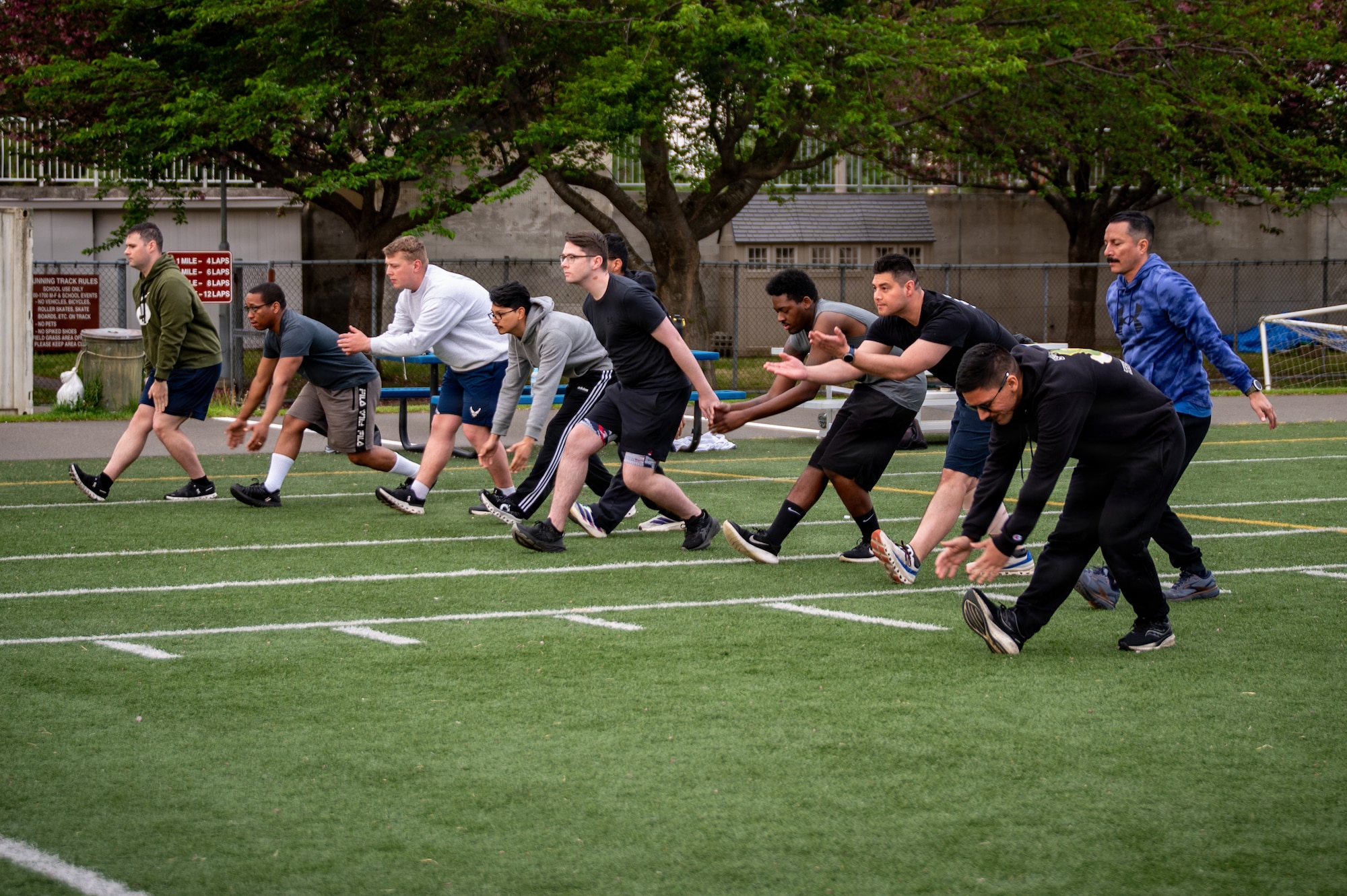 Participants perform dynamic warm-up exercises during a running clinic.