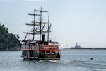 A local “black ship”-themed scenic tour boat transits as U.S. Navy Arleigh Burke-class guided-missile destroyer USS Howard (DDG 83), right, arrives at Shimoda, Japan for the 87th annual Black Ship Festival, May 14, 2026. The festival commemorates the 1854 arrival of Commodore Matthew C. Perry and his “black ships” to Shimoda, and the subsequent signing of the Japan-U.S. Treaty of Peace and Amity marking the start of diplomacy and trade between both countries. Howard is forward-deployed and assigned to Destroyer Squadron (DESRON) 15, the Navy’s largest DESRON and U.S. 7th Fleet’s principal surface force. U.S. 7th Fleet, the Navy’s largest forward-deployed numbered fleet, routinely interacts and operates with allies and partners in preserving a free and open Indo-Pacific. (U.S. Navy photo by Chief Mass Communication Specialist Taylor DiMartino)