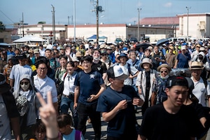 Japanese community members make their way onto the flight line at the start of the 2026 U.S.-Japan Friendship Festival at Yokota Air Base, Japan, May 16, 2026.