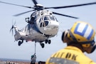 U.S. Sailors embarked aboard the forward-deployed amphibious assault ship USS Tripoli (LHA 7), attach supplies to an EC-255 Super Puma, assigned to the Maritime Pre-Positioning Force, during a vertical replenishment evolution in the U.S. Central Command area of responsibility, May 10, 2026. Tripoli is deployed to the U.S. 5th Fleet area of operations to support maritime security and stability in the Middle East. (U.S. Marine Corps photo)