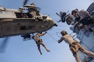 U.S. Marines with Maritime Raid Force, 31st Marine Expeditionary Unit, rappel out of an MH-60S Sea Hawk, assigned to Helicopter Sea Combat (HSC) Squadron 25, during helicopter and roping sustainment training aboard the forward-deployed amphibious assault ship USS Tripoli (LHA 7) in the U.S. Central Command area of responsibility, May 8, 2026. Tripoli is deployed to the U.S. 5th Fleet area of operations to support maritime security and stability in the Middle East. (U.S. Marine Corps photo)