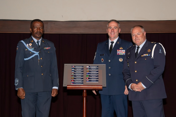 U.S. Air Force Chief Master Sgt. Raun M. Howell, command chief master sergeant of Air University; Warrant Officer Festus Mwelwa, command senior master air warrant officer of the Zambian Air Force; and Chief Warrant Officer Theodorus Gerardus Willem Venhovens, command senior master air warrant officer of the Royal Netherlands Air Force, pose for a photo during the International Honor Roll ceremony at Maxwell-Gunter Annex, Maxwell Air Force Base, Alabama, April 10, 2026.
