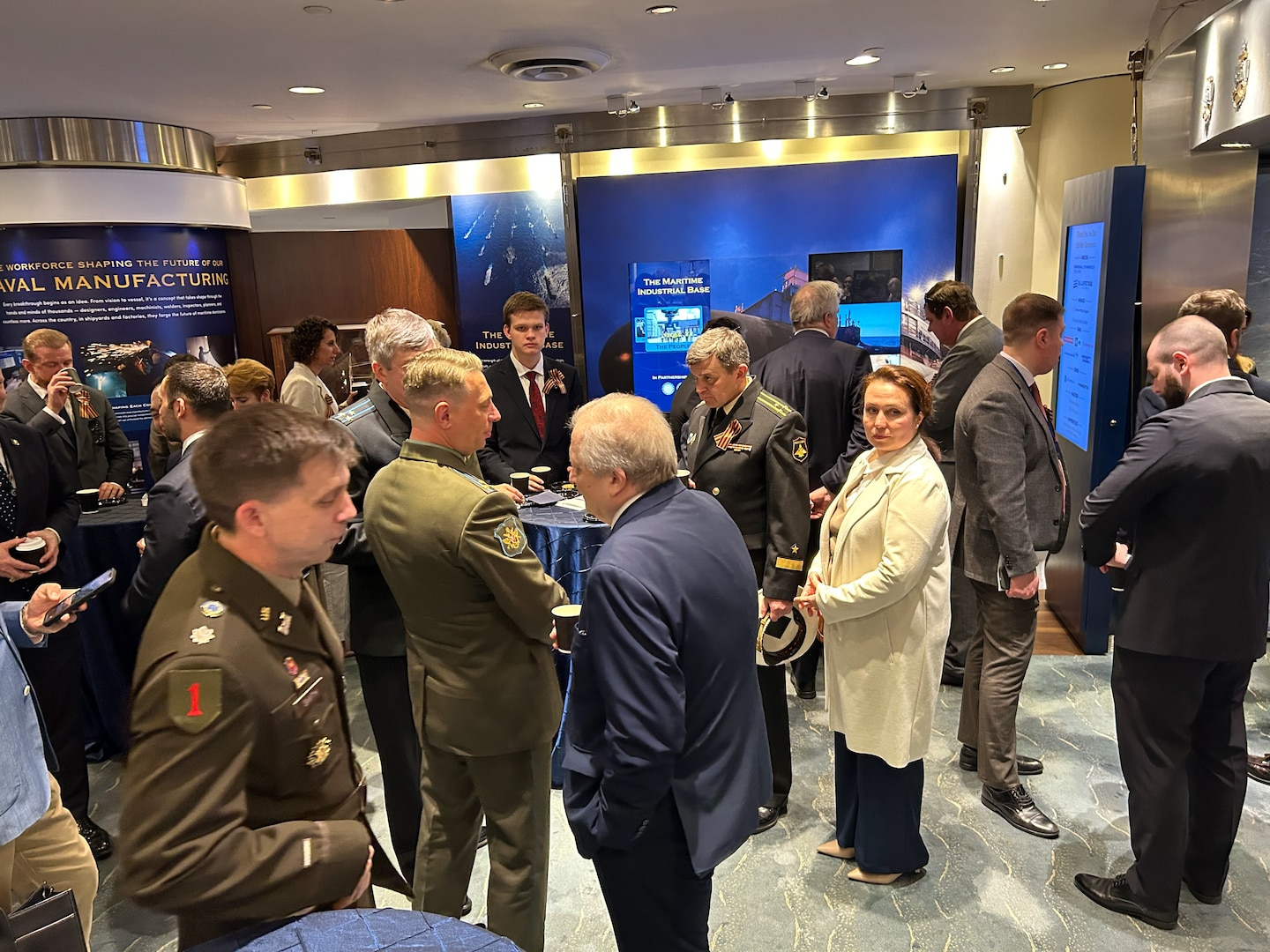 Attendees mingle at a reception following the special ceremony held by the U.S.-Russia Joint Commission on POW/MIAs at the Navy Memorial Visitors Center in Washington, D.C., May 15 for submariners of the USS Wahoo, lost during World War II, during which soil, water, and video from the site where the Wahoo sank, as well as a model of the Wahoo, was given to the U.S. by Russia. The Russian Federation Ambassador to the United States, H. E. Alexander Darchiev, presented the containers of soil and water, the video, and the model to retired Air Force Gen. Robert “Doc” Fogelsong, the United States Side Chairman of the USRJC, who accepted on behalf of the United States and the families of the USS Wahoo submariners. (Photo by Sean Everette, Defense POW/MIA Accounting Agency)