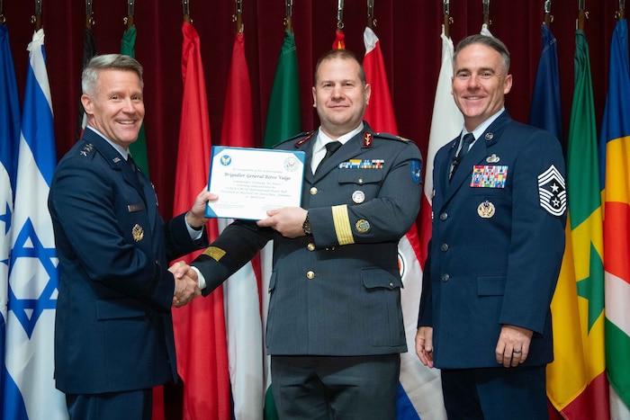 U. S. Air Force Lt. Gen. Daniel H. Tulley, Air University commander and president, and Chief Master Sergeant Raun M. Howell, AU command chief, induct Estonian Air Force Commander Brig Gen Riivo Valge into the 2026 International Honor Roll at Maxwell Air Force Base, Alabama, Apr. 10, 2026.