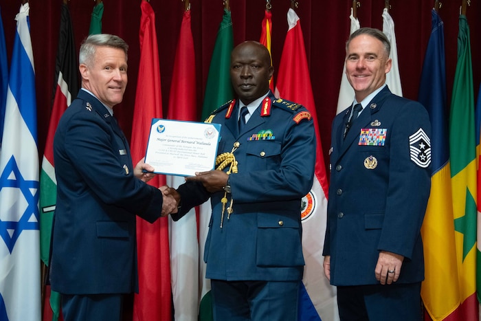 U. S. Air Force Lt. Gen. Daniel H. Tulley, Air University commander and president, and Chief Master Sergeant Raun M. Howell, AU command chief, induct Kenyan Air Force Commander Maj. Gen. Bernard Waliaula into the 2026 International Honor Roll at Maxwell Air Force Base, Alabama, Apr. 10, 2026.