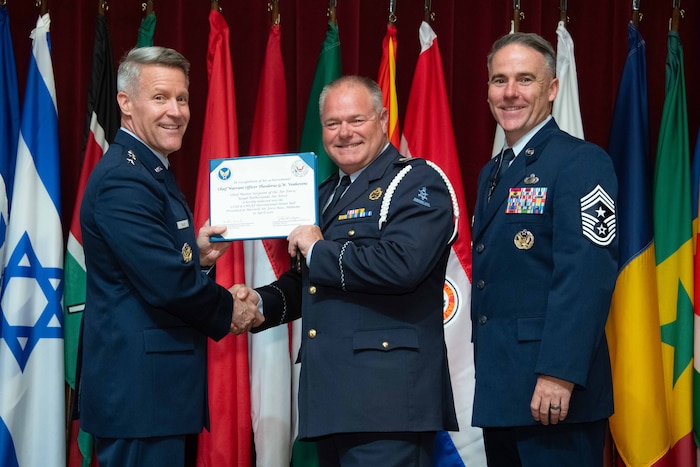U. S. Air Force Lt. Gen. Daniel H. Tulley, Air University commander and president, and Chief Master Sergeant Raun M. Howell, AU command chief, induct Royal Netherlands Air Force Chief Master Sergeant of the Air Force Chief Warrant Officer Theodorus Geradus Willem Venhovens the 2026 International Honor Roll at Maxwell Air Force Base, Alabama, Apr. 10, 2026.