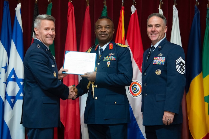 U. S. Air Force Lt. Gen. Daniel H. Tulley, Air University commander and president, and Chief Master Sergeant Raun M. Howell, AU command chief, induct Nigerian Air Force Air Chief of Staff Air Marshal Sunday Kelvin Aneke into the 2026 International Honor Roll at Maxwell Air Force Base, Alabama, Apr. 10, 2026.