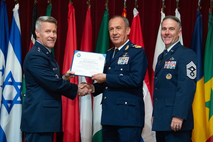 U. S. Air Force Lt. Gen. Daniel H. Tulley, Air University commander and president, and Chief Master Sergeant Raun M. Howell, AU command chief, induct Paraguayan Air Force Commander Gen Julio Rubén Fullaondo Céspedes into the 2026 International Honor Roll at Maxwell Air Force Base, Alabama, Apr. 10, 2026.