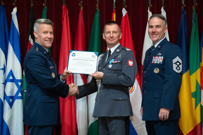 U. S. Air Force Lt. Gen. Daniel H. Tulley, Air University commander and president, and Chief Master Sergeant Raun M. Howell, AU command chief, induct Inspector of the Polish Armed Forces Maj. Gen. Ireneusz Nowak into the 2026 International Honor Roll at Maxwell Air Force Base, Alabama, Apr. 10, 2026.