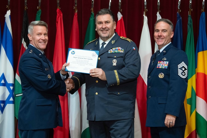 U. S. Air Force Lt. Gen. Daniel H. Tulley, Air University commander and president, and Chief Master Sergeant Raun M. Howell, AU command chief, induct Czech Air Force Commander Maj. Gen. Petr Čepelka into the 2026 International Honor Roll at Maxwell Air Force Base, Alabama, Apr. 10, 2026.