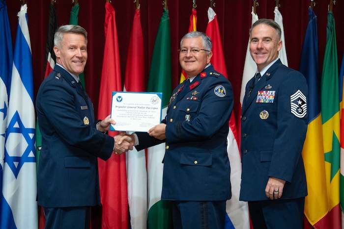 U. S. Air Force Lt. Gen. Daniel H. Tulley, Air University commander and president, and Chief Master Sergeant Raun M. Howell, AU command chief, induct Honduran Air Force Commander Brig. Gen. Walter Paz Lopez into the 2026 International Honor Roll at Maxwell Air Force Base, Alabama, Apr. 10, 2026.