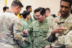 U.S. Soldiers and members of the Singapore Armed Forces trade unit patches after the closing ceremony of Exercise Tiger Balm 2026 at Joint Base Lewis McChord, Washington, May 15, 2026. This ceremony concluded the 45th iteration of Exercise Tiger Balm, which is an annual bilateral exercise between the United States and Singapore armies focused on building combat readiness, strengthening interoperability and demonstrating regional security partnership. Photo by Sgt. Abigail Clark.