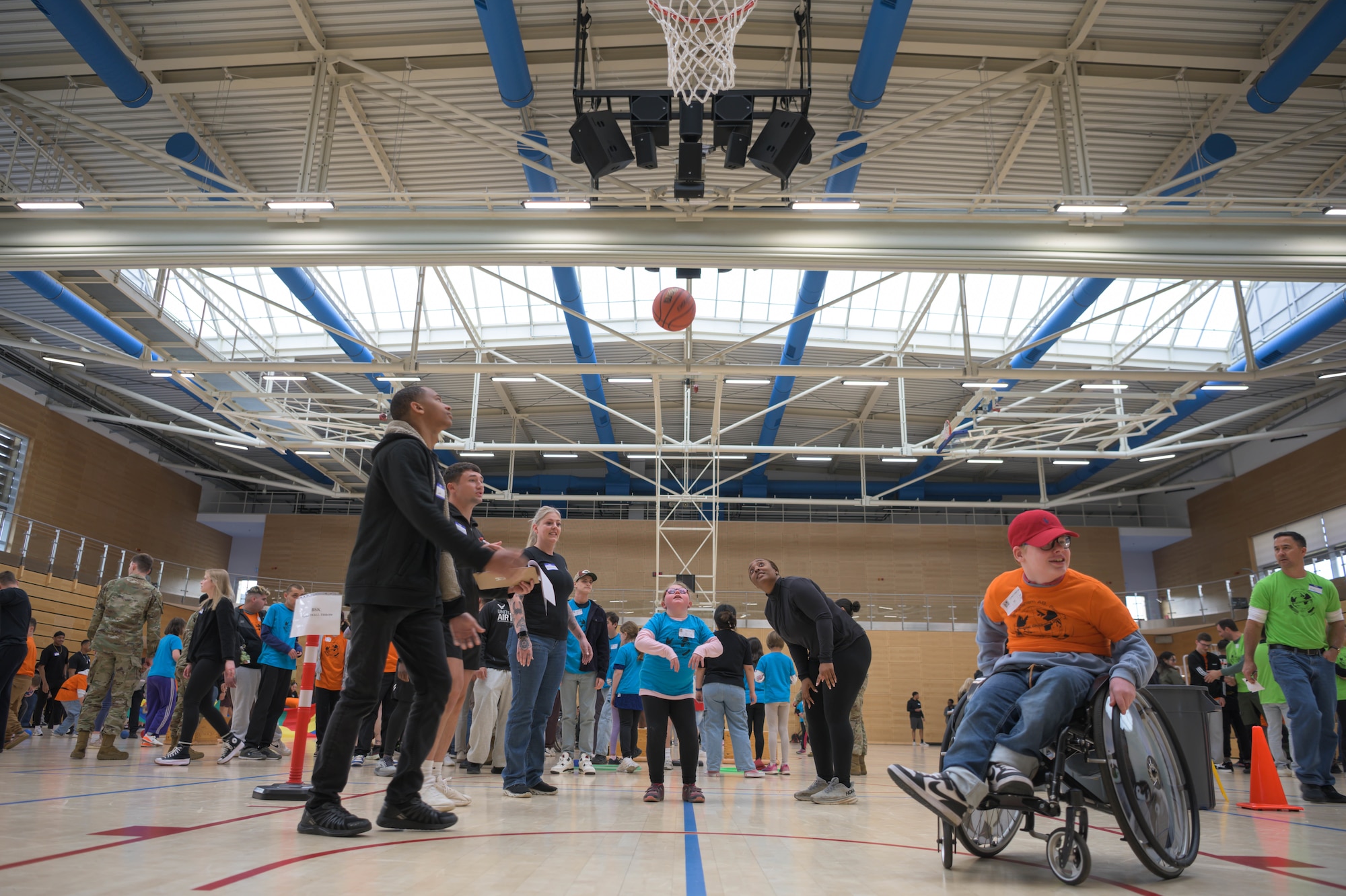 A group of people play basketball.