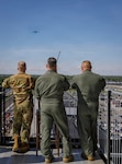 Indiana Army National Guard Col. Scott Oden, U.S. Air Force Capt. Nate Padgett and Capt. Cory Beck watch as a plane from Grissom Air Force Base arrives over Indianapolis Motor Speedway for a planned flyover at the Grand Prix in Speedway, Indiana, May 9, 2026. To meet the requirements of national broadcast, the flight team has about a three-second target window for the plane to come over the speedway. Photo by Sgt. Austin Goss.