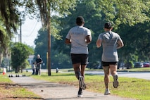 Service members running outside during the Warrior Challenge.