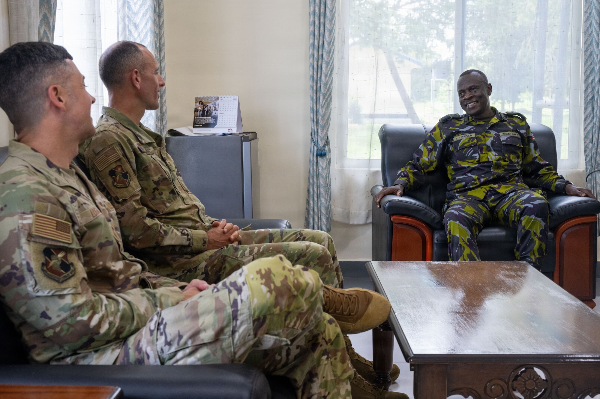 U.S. Air Force Col. Gabriel Brown, 406th Air Expeditionary Wing commander, center, and U.S. Air Force Chief Master Sgt. Jason Logan, 406th AEW command chief, left, meet with Brig Gen Lazarus P. Wafula, Kenya Navy Base – Manda Bay, Base Commander, right, at Manda Bay, Kenya, May 6, 2026. The meeting focused on continued cooperation between U.S. and Kenyan forces operating in the region. The meeting highlighted the importance of strong partnerships in supporting regional stability and shared security objectives. (U.S. Air Force photo by Maj. Porter Maerz)