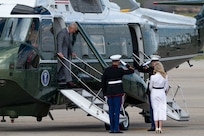King Charles III exits a helicopter during a departure ceremony.
