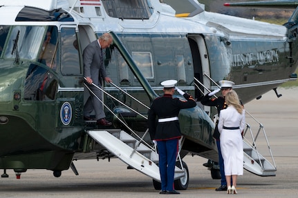 King Charles III exits a helicopter during a departure ceremony.