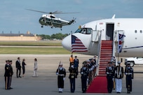 A helicopter transports King Charles III to a departure ceremony as the Joint Service Color Guard stand at attention.