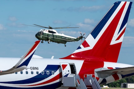 A helicopter transports King Charles III to a departure ceremony.