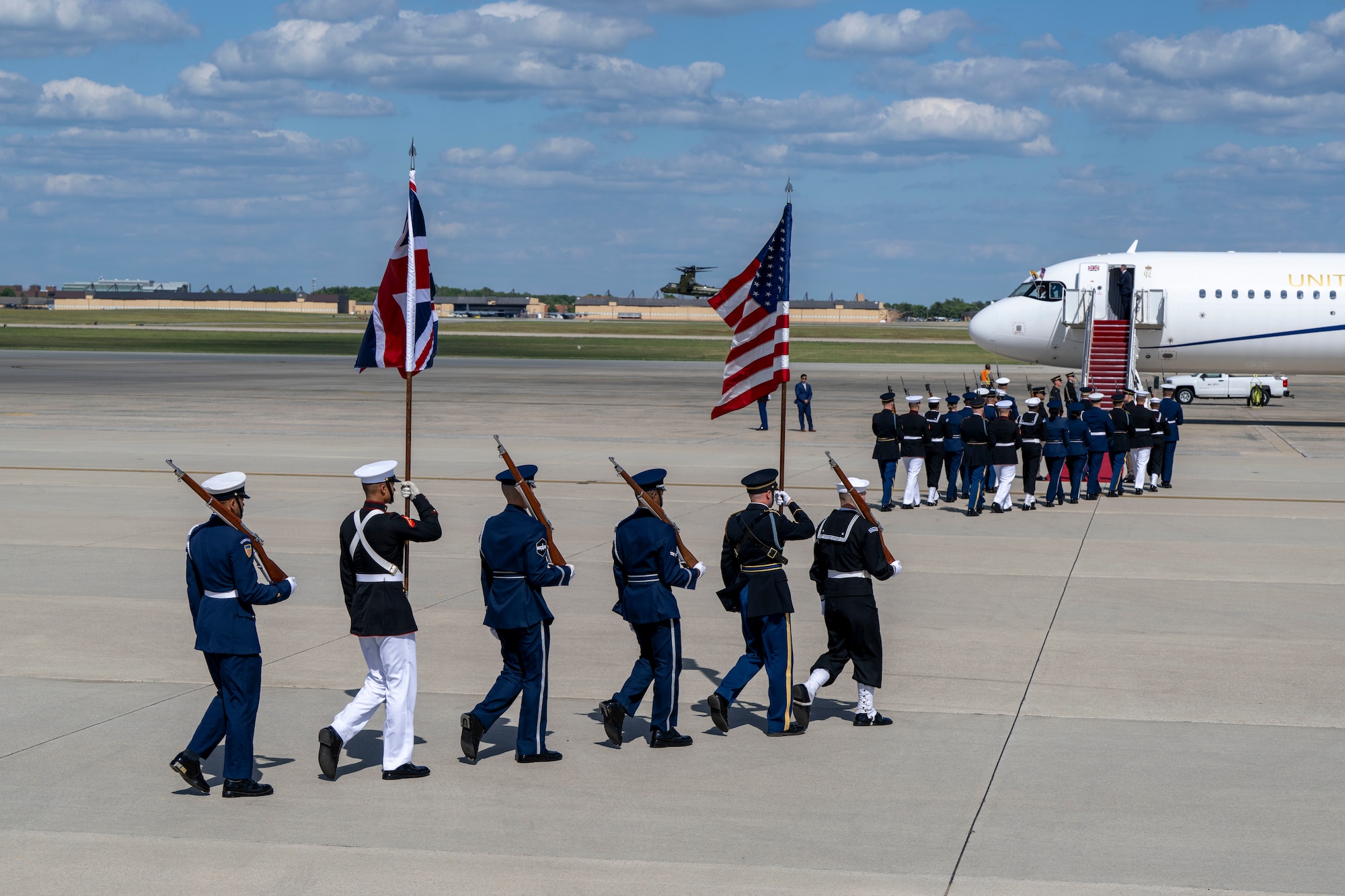 The Joint Service Color Guard march to their positions during a military departure ceremony.