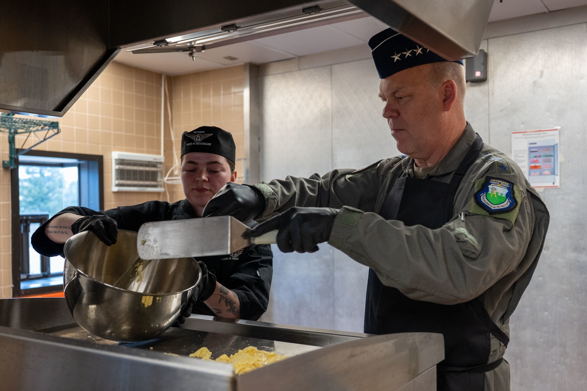 Gen. Davis demonstrates how to make breakfast at Missile Chef learning facility.