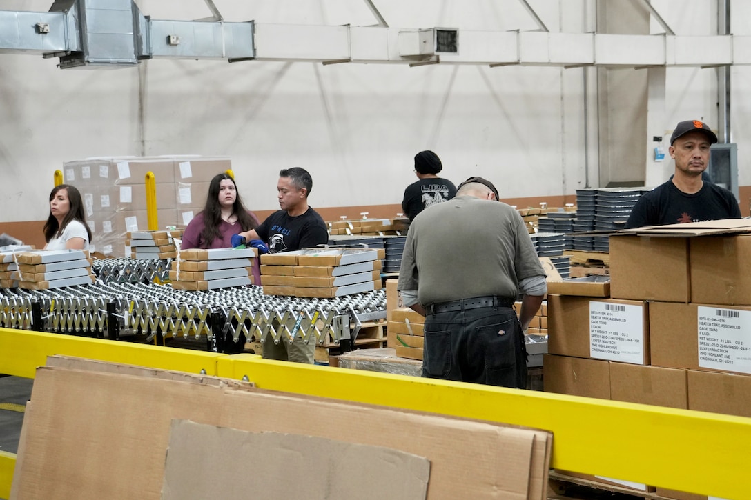 People putting together ration kits in a warehouse.