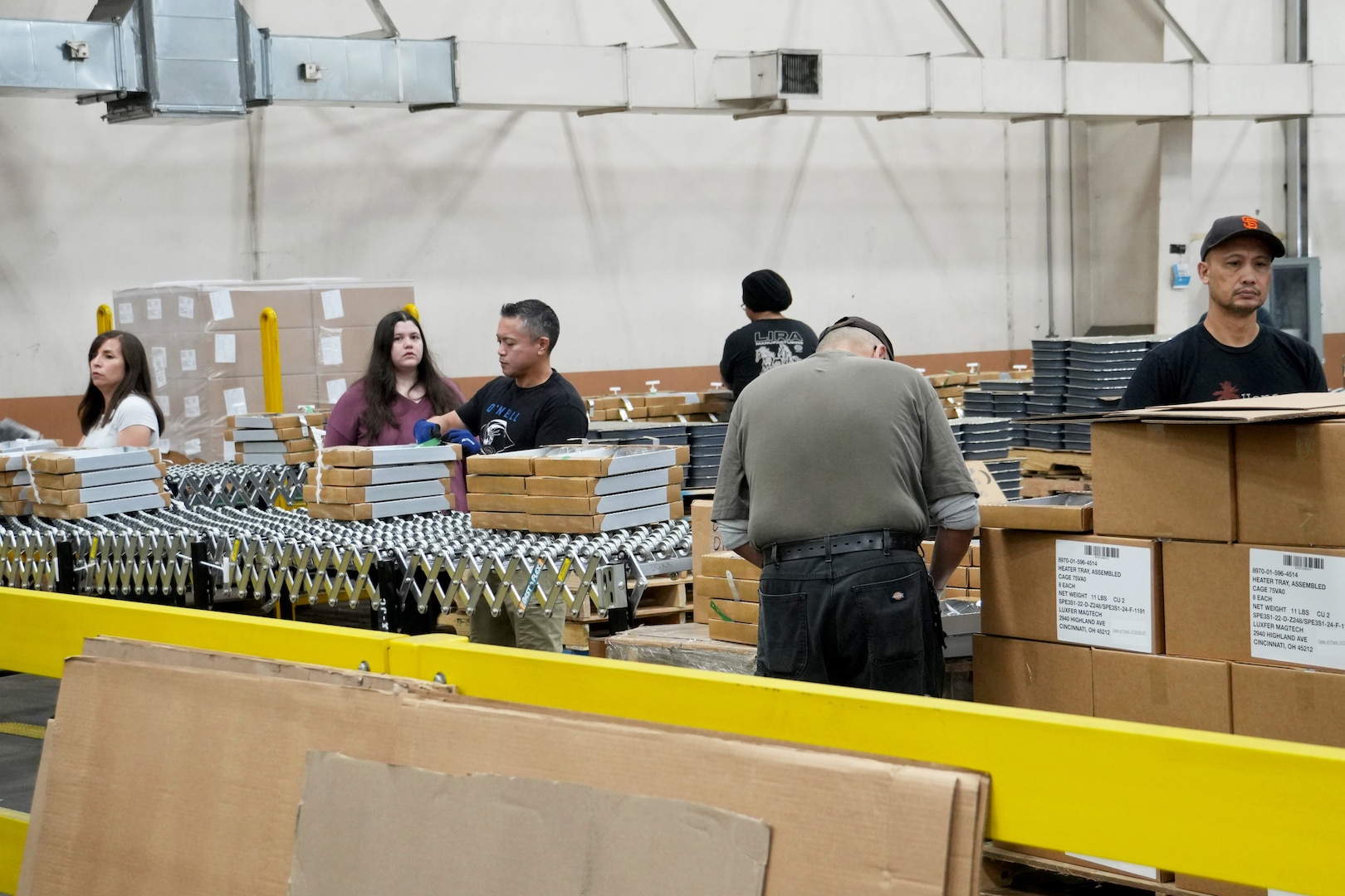 People putting together ration kits in a warehouse.