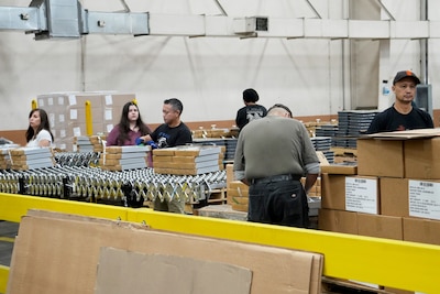 People putting together ration kits in a warehouse.