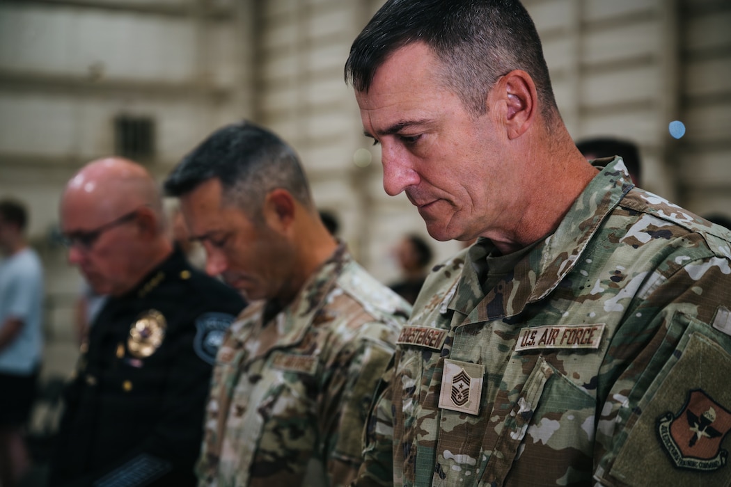 U.S. Air Force Chief Master Sgt. Nathan Chrestensen, 56th Fighter Wing command chief, bows his head during the invocation at the 2026 Police Week opening ceremony at Luke Air Force Base, Arizona, May 11, 2026. The ceremony fostered a spirit of service by bringing together Airmen, law enforcement, and community members to honor the fallen and reaffirm support for active personnel. (U.S. Air Force photo by Senior Airman Katelynn Jackson)