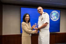 Vice Adm. Johnny Wolfe Jr., director for Portfolio Acquisition Executive (PAE) Strategic Systems Programs (SSP), presents Ms. Kelly Lee, the director of the plans and programs division at PAE SSP and a member of the Senior Executive Service, with the Director’s Award at the biannual Steering Task Group (STG) meeting in Washington D.C., on May 13, 2026. 

With more than 35 years of service to the program, Ms. Lee has provided technical expertise and a high-level understanding of weapon system processes that have contributed to critical developments within the Trident II D5 Life Extension (D5LE) program. The Director’s Awards are presented annually with the purpose of recognizing the personal contributions of the PAE SSP government team. To date, only 50 people have received the Director’s Award, including this year’s recipients. Wolfe also presented this year’s Fleet Ballistic Missile Lifetime Achievement Awards at the STG meeting.